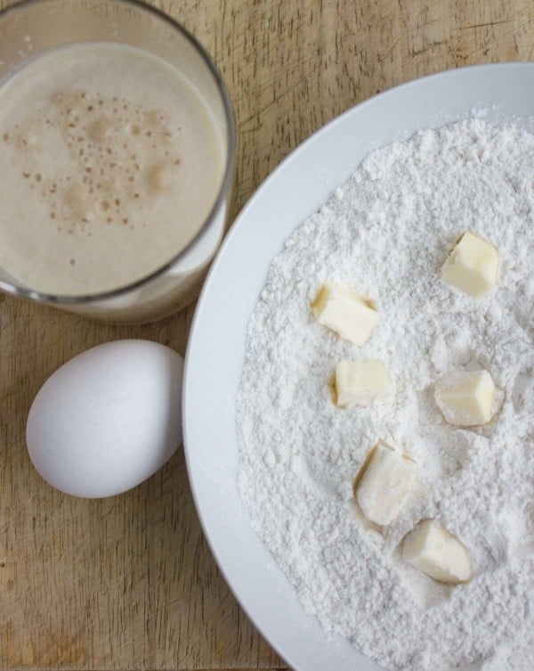 ingredients for making a soft burger buns recipe arranged on a table