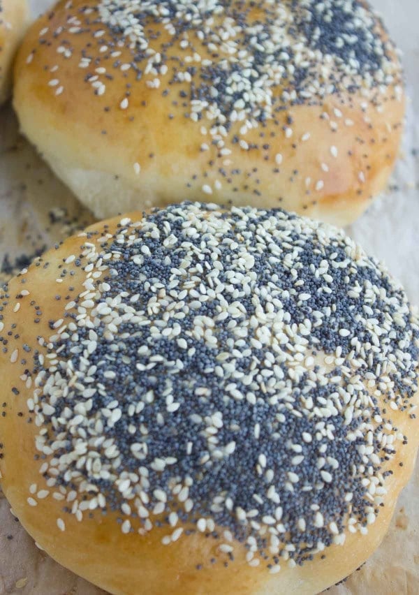 close up of a sesame and poppy seed topped soft burger bun