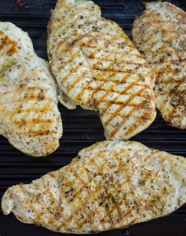 Chicken Breasts seasoned and on the grill.