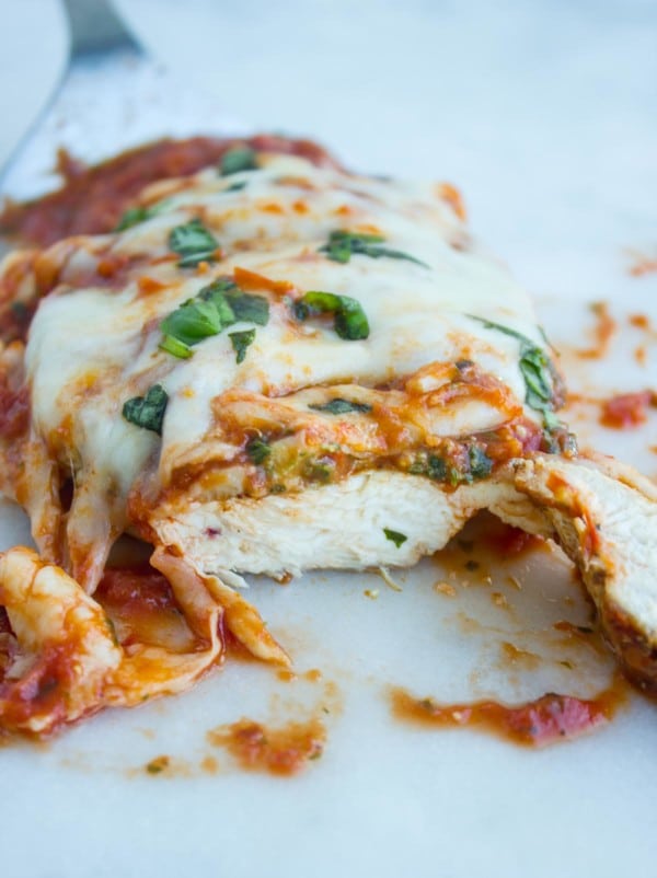 Grilled Chicken Parmesan cooked and sliced to see juicy chicken inside.