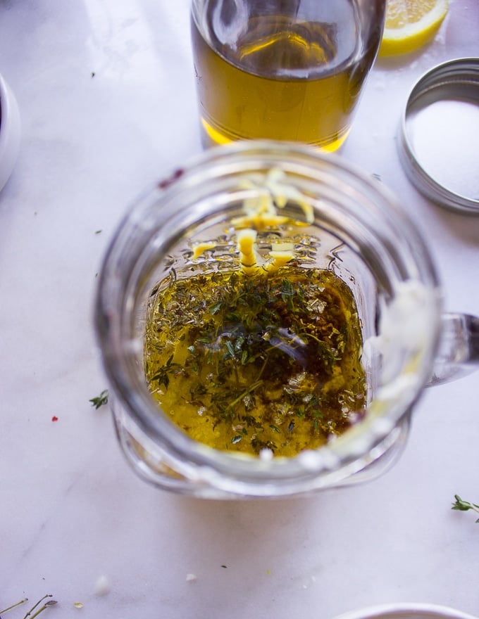 All ingredients for the greek salad dressing are added in a glass jar