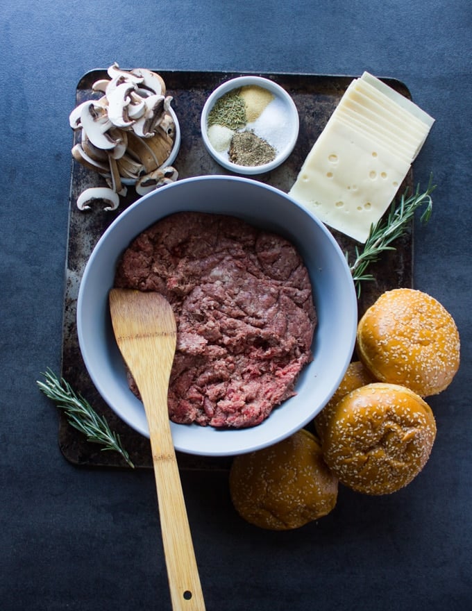 Ingredients for the Mushroom Swiss burger recipe including the ground beef, brioche buns, the burger seasoning, sliced mushrooms and swiss cheese