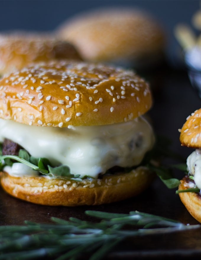 The burger patty put on the bread showing the melted swiss cheese in the mushroom swiss burger