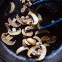 sliced Mushrooms cooking in the same skillet