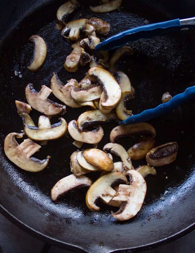 sliced Mushrooms cooking in the same skillet 