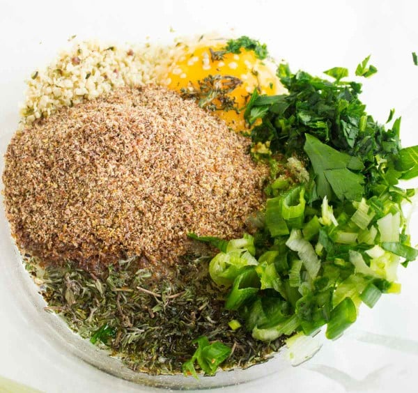 ingredients for gluten-free zucchini fritters in a bowl ready to be mixed