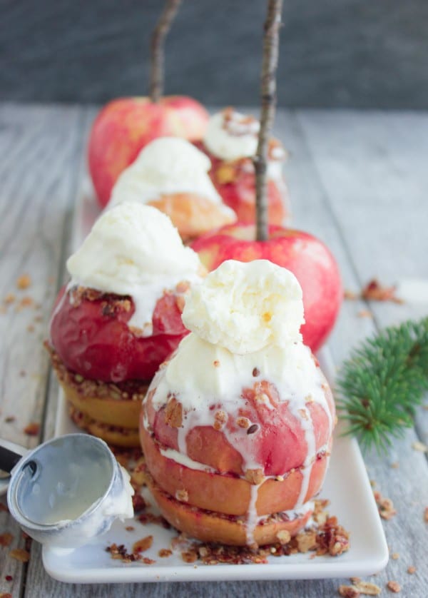 Baked Apples with Granola Crunch topped with scoops of vanilla ice cream