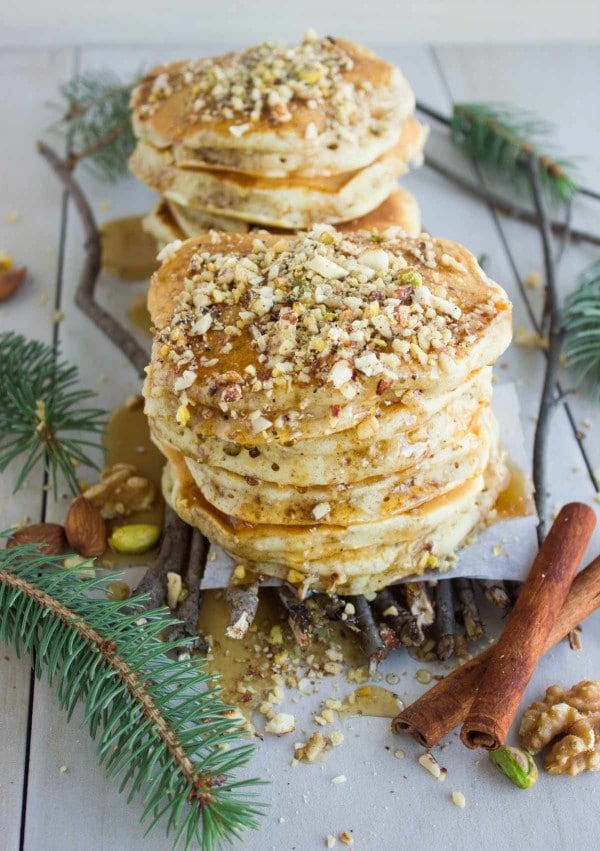 side view of two stacks of Baklava Pancakes with Maple Syrup and chopped pistachios on top