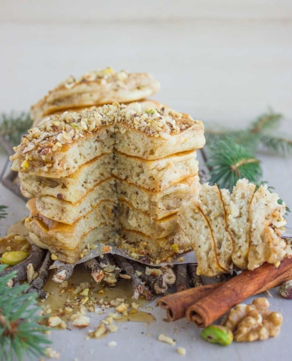 a stack of fluffy Baklava Pancakes with Maple Syrup with one wedge cut out