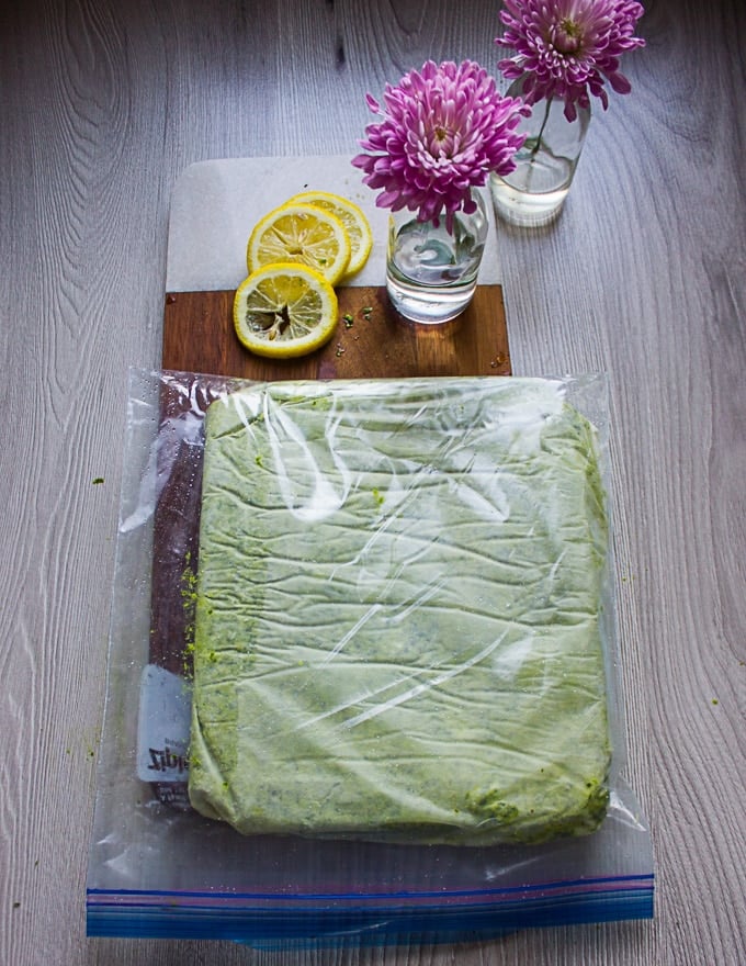 The frozen sheet of basil pesto in a ziploc bag ready for storing in the freezer