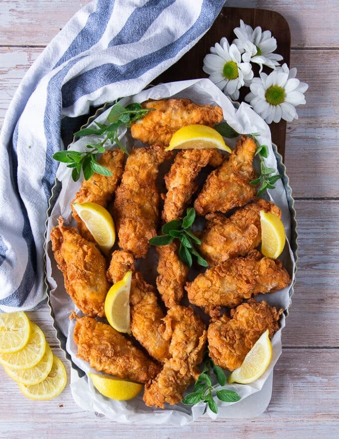 A large platter of chicken fingers ready to serive 