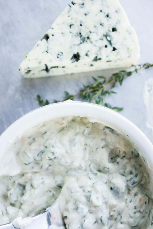 overhead shot of a small white dish with Garlic Blue Cheese Dip