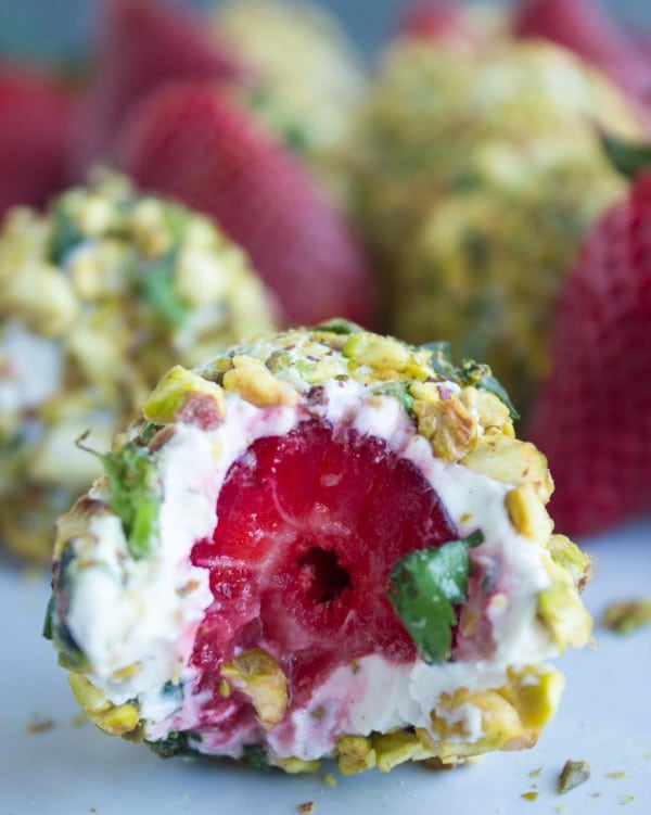 Close-up of a Goat Cheese Pistachio Coated Strawberry with a bite taken from