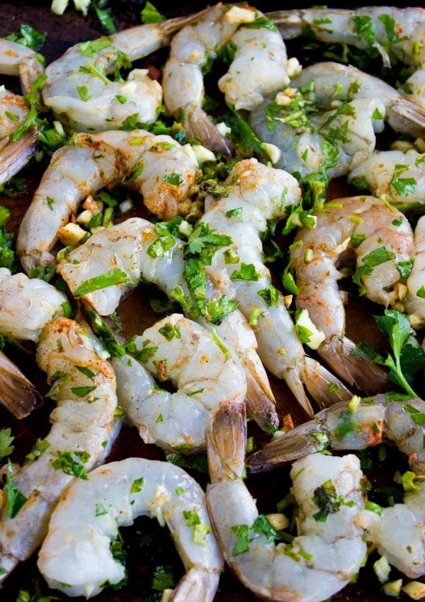 Whole Shrimp being tossed with olive oil and herbs