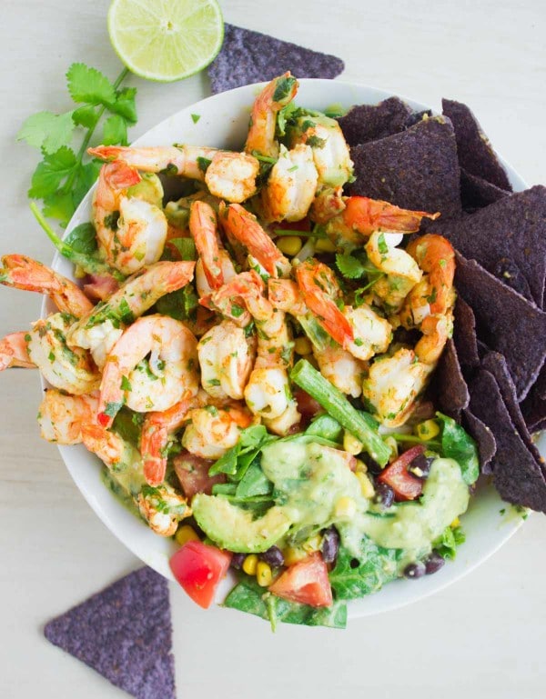 Shrimp Salad with Avocado Dressing served in a white bowl with purple nacho chips