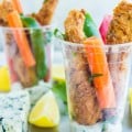 Spicy Fried Chicken Fingers in a plastic glass cup