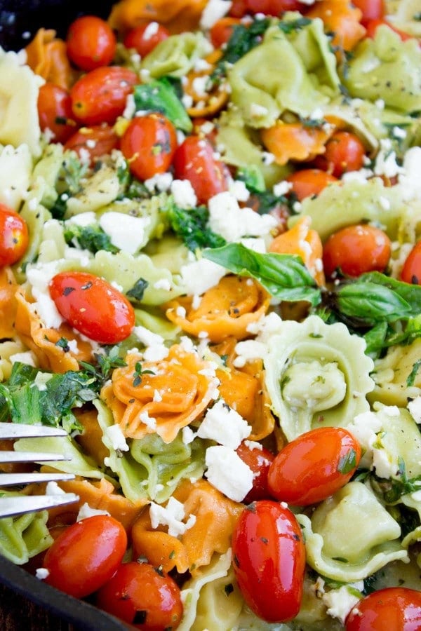 close-up of 10 Minute Greek Cheese Tortellini sprinkled with crumbled feta and fresh basil