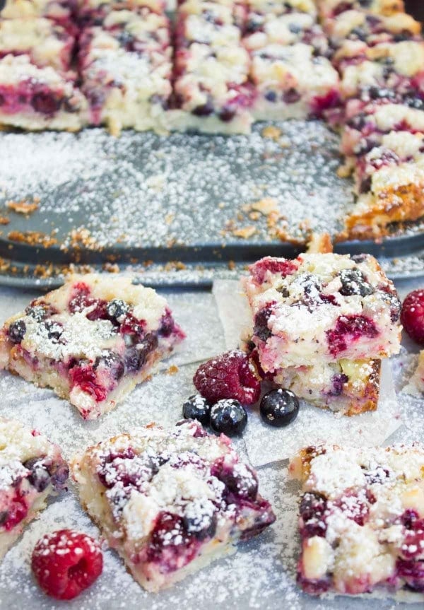 Sugar-dusted Berry Citrus Poppy Seed Bars cut into squares