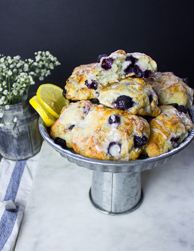 Side view of a plate of drop biscuits with glaze