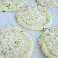 Mashed Potato Rosemary Crisps being sprinkled with grated cheese before baking