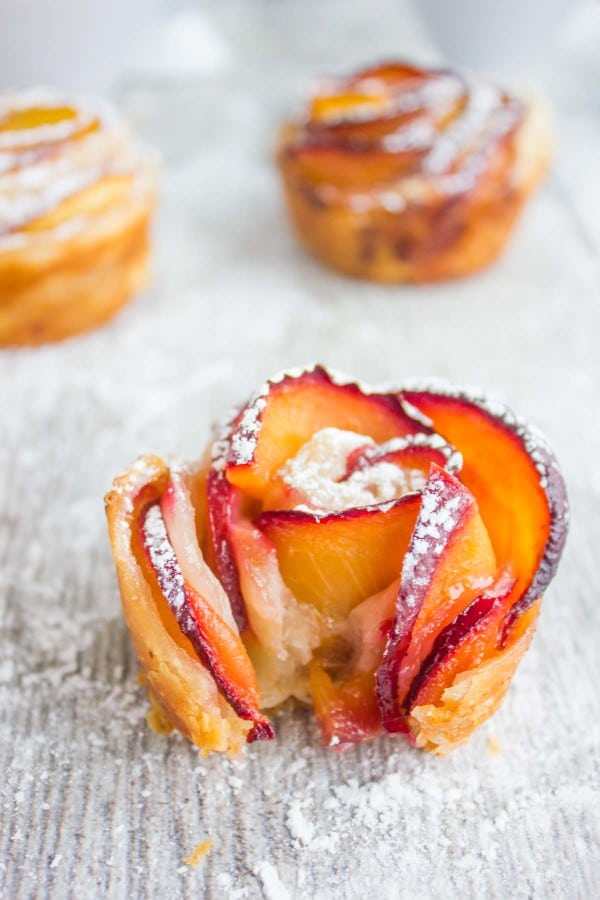 close up on a Peach Plum Rose Tart with a bite taken out the front