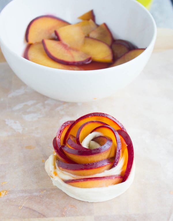 Rose shaped tart with plum and peach slices before baking