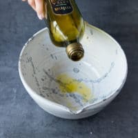 coating a bowl with olive oil.
