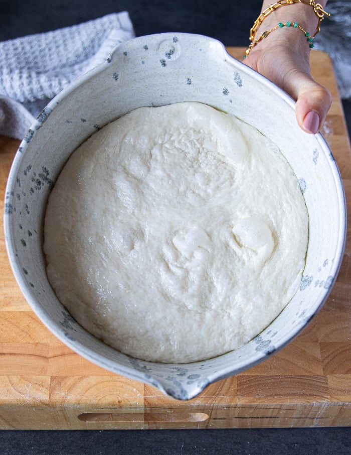 Pizza dough ready and risen for the first time and has doubled in size in the bowl