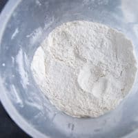 Flour and salt are mixed in a bowl.