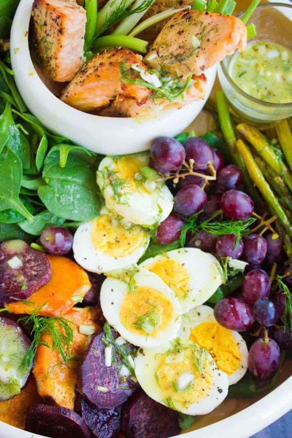 Salmon Asparagus Sweet Potato Nicoise arranged on a big platter with grapes, boiled eggs and broiled salmon and asparagus