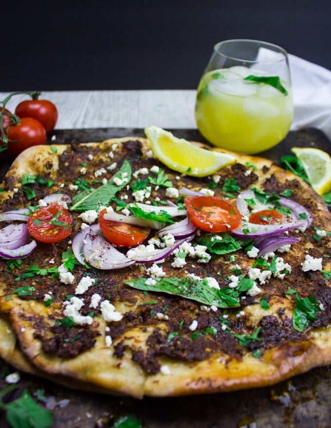 Close up Turkish pizza Lahmacun served with a cold drink and flat right out of the oven