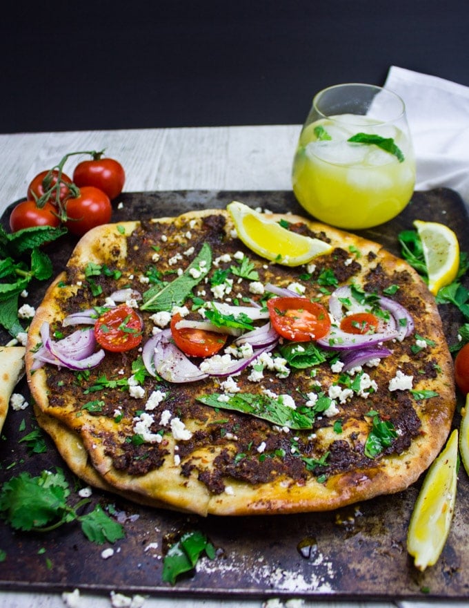 side view of the whole pizza lahmacun served flat with toppings