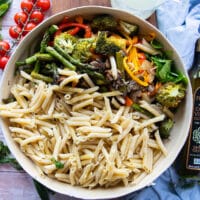 Adding the pasta to the veggies and sauce.