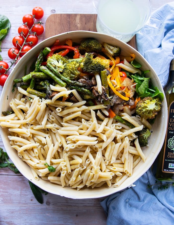 Adding the pasta to the veggies and sauce.