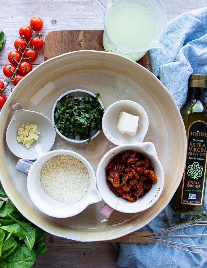 ingredients for the pasta primavera sauce including parmesan, sun dried tomatoes, herbs, garlic and cream cheese