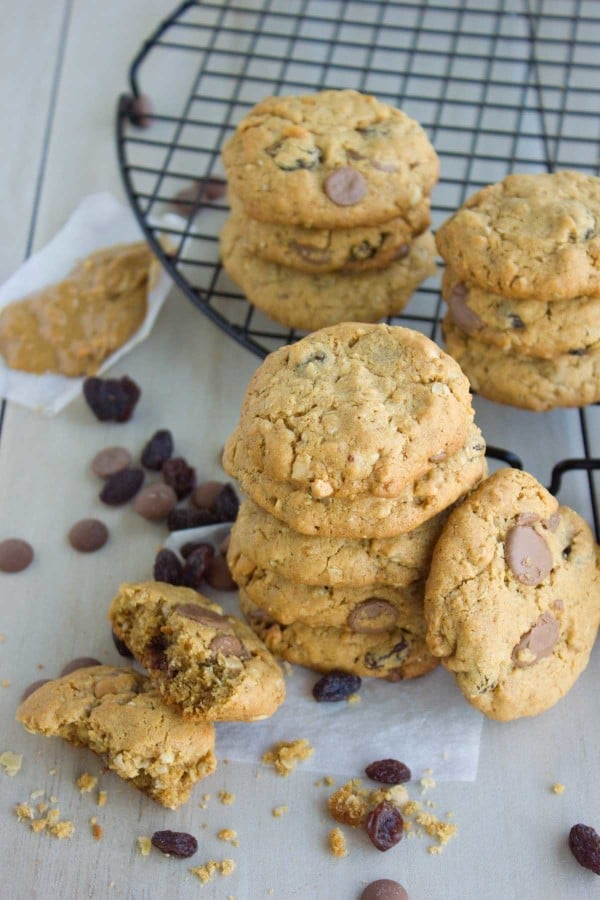 Peanut Butter Chocolate Chip Cookies stacked on top of each other with some chocolate chips scattered between them