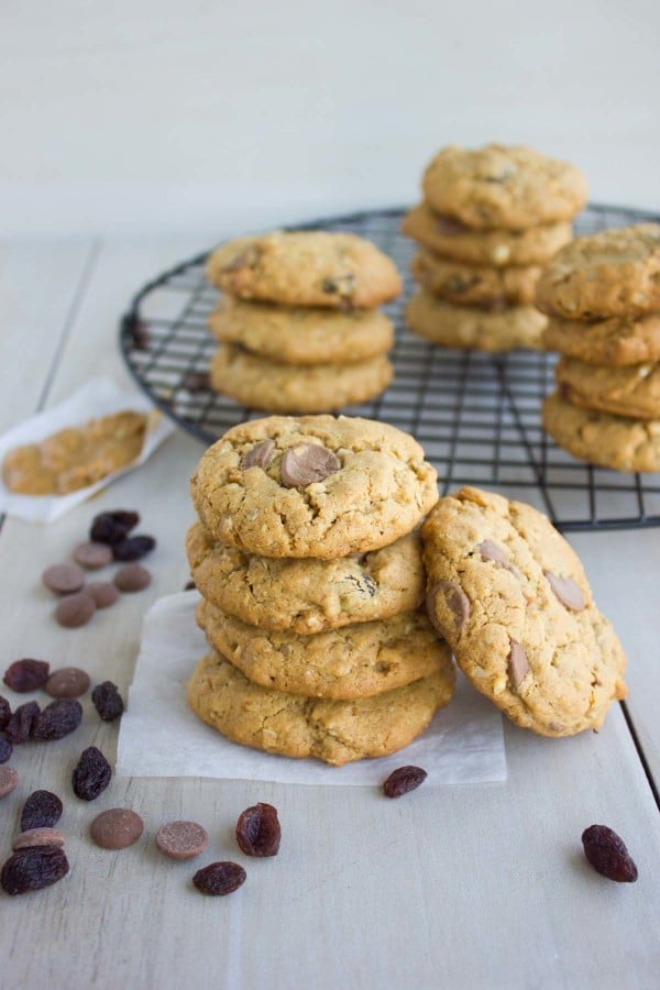 Peanut Butter Chocolate Chip Cookies stacked on top of each other with some chocolate chips on the side