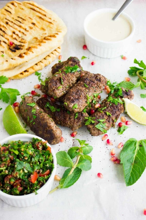 full platter of lamb kebab with grilled bread, tahini sauce, tabouleh salad and lots of lime