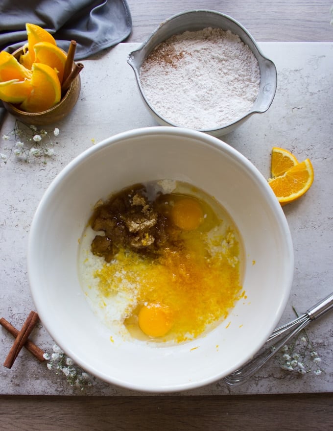 A bowl with the wet ingredients mixed together - the eggs, sugar, oil, buttermilk, orange zest, orange juice