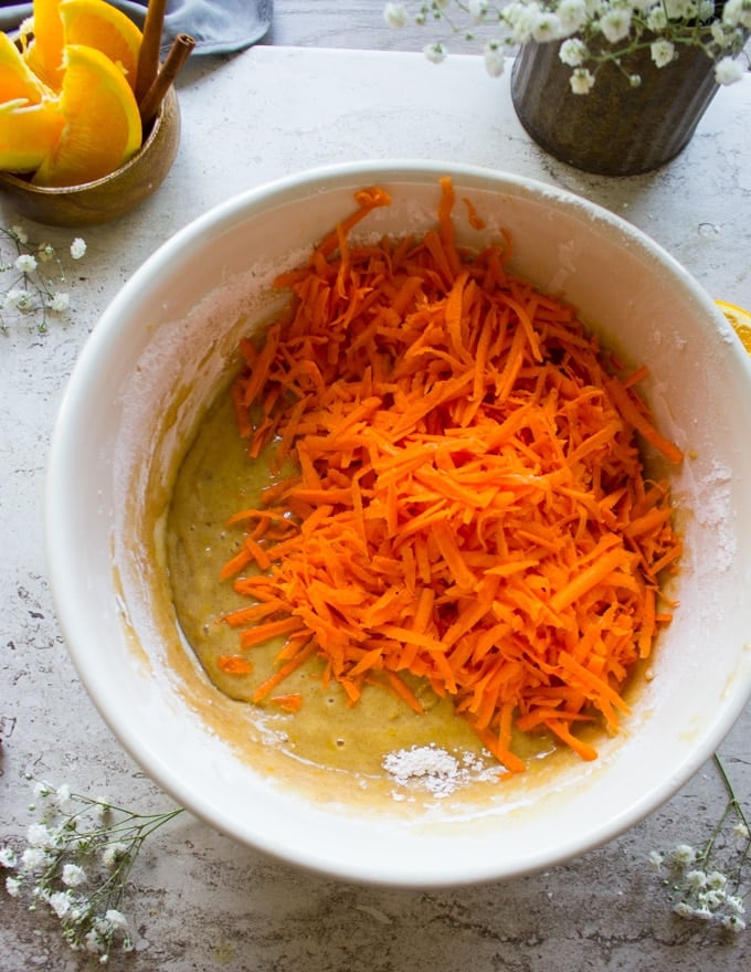 The shredded carrots going in to the carrot cake batter