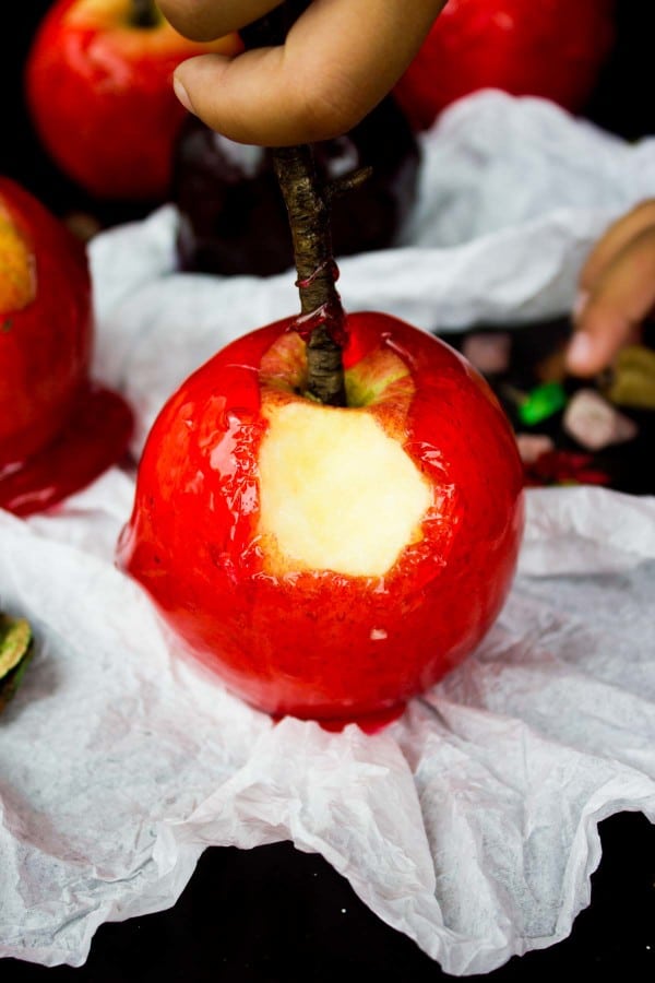 A candy apple with a bite in it