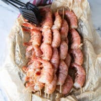 raw shrimp skewered on wooden sewers for grilling
