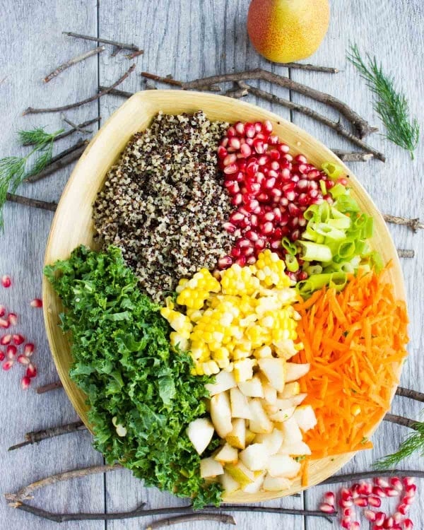 all ingredients for Quinoa Autumn Harvest Salad neatly piled up in a salad bowl