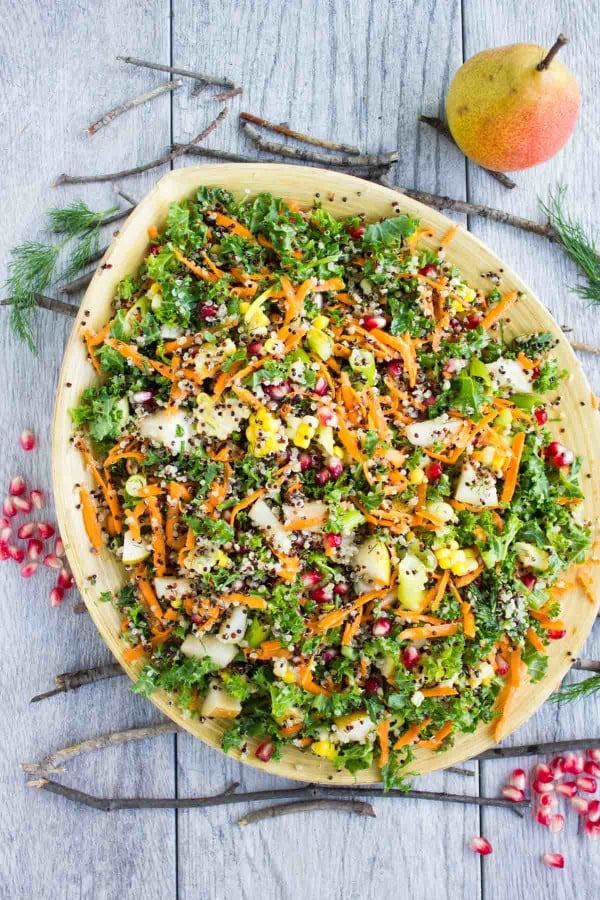 overhead shot of Quinoa Autumn Harvest Salad served in a big wooden bowl placed on a rustic table