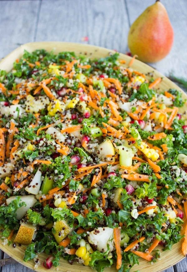 overhead shot of Quinoa Autumn Harvest Salad served in a big wooden bowl placed on a rustic table