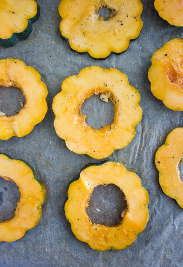 slices of acorn squash on a baking tray