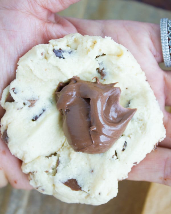 chocolate chip cookie dough being stuffed with Nutella
