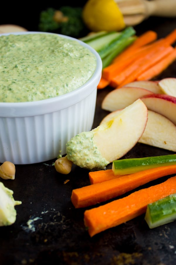 side view of Garlic Kale Hummus Dip with veggie sticks on the side