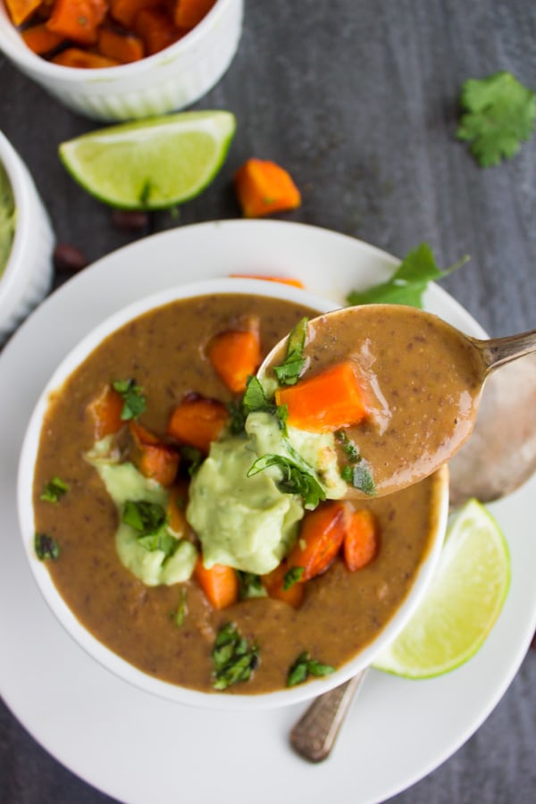 Cuban Sweet Potato Black Bean Soup topped with avocado crema and roasted sweet potato cubes