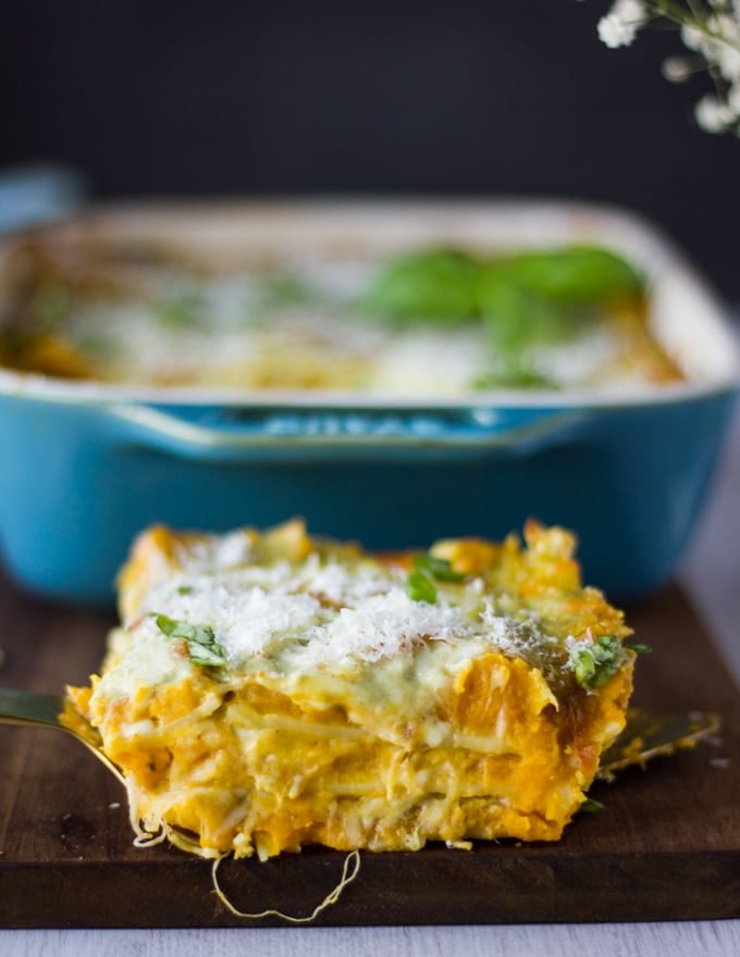 detailed close up of one slice of lasagna showing the layers of butternut squash, basil sauce and cheeses